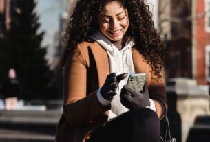 Happy woman using smartphone with good UI/UX.