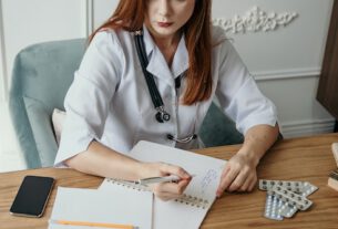 Doctor with laptop practicing telemedicine