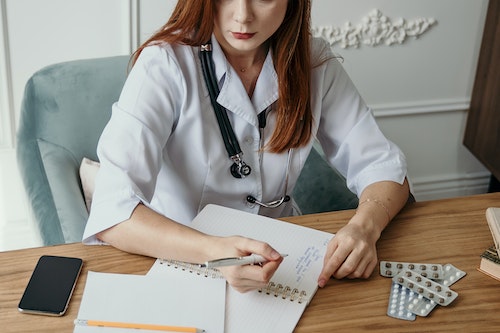 Doctor with laptop practicing telemedicine