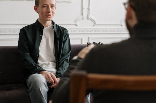 Teenage boy talking to psychiater through telepsychiatry